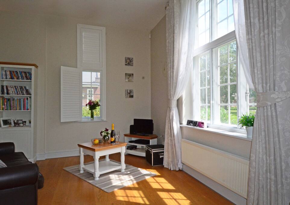 Open plan living-dining-kitchen with wood floors