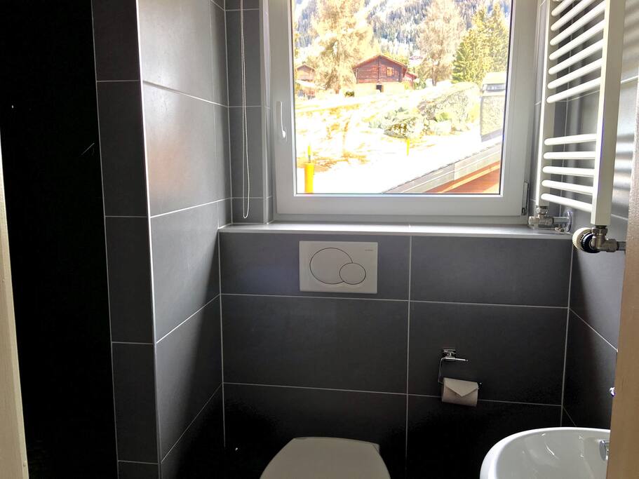Cosy bathroom with shower and views of Le Rouge ski lift out back