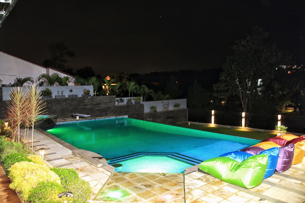 Pool area at night with LED color-changing pool lights