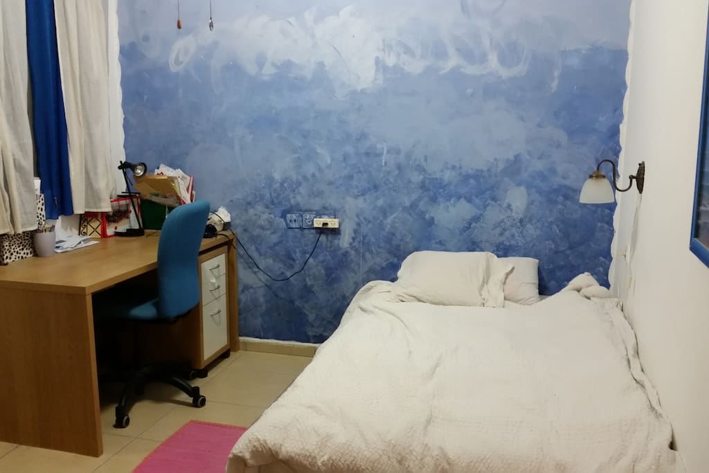 cosy private room with comfortable bad with a window and a desk for writting memories from unforgetable trip