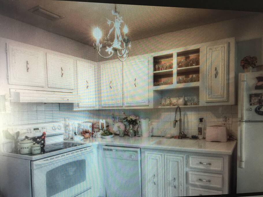 Kitchen with modern appliances, includes dishwasher, oven, fridge and microwave not pictured. Separate eating area both in the kitchen and in the living room.