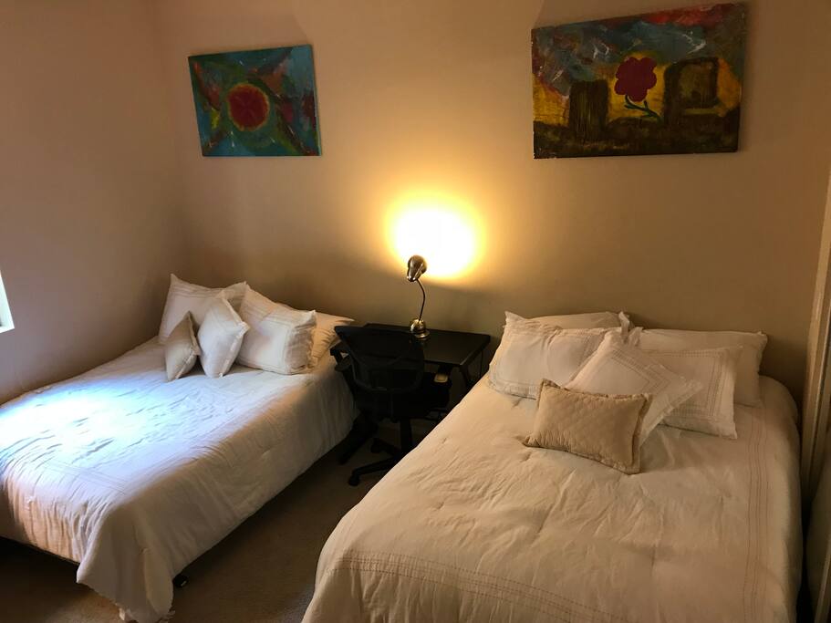 Your bedroom has 2 full sized beds and a desk with a chair