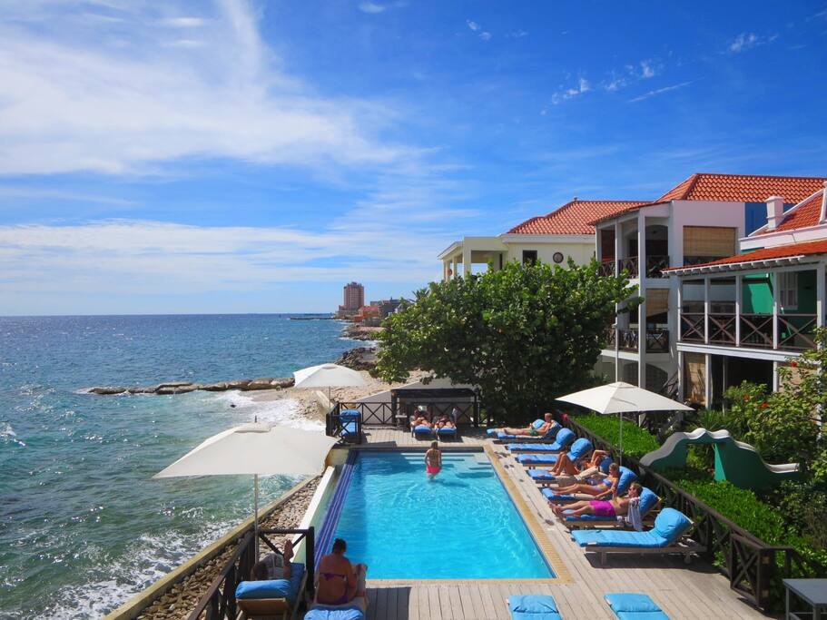 Your balcony offers stunning views over the pool and ocean.