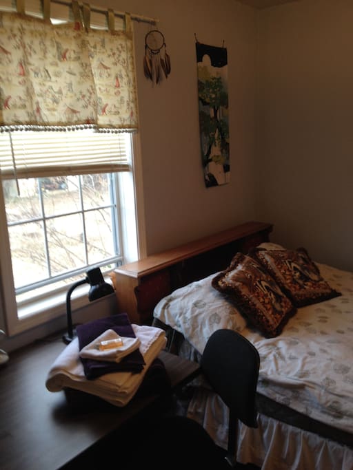 Bed, desk, window.
