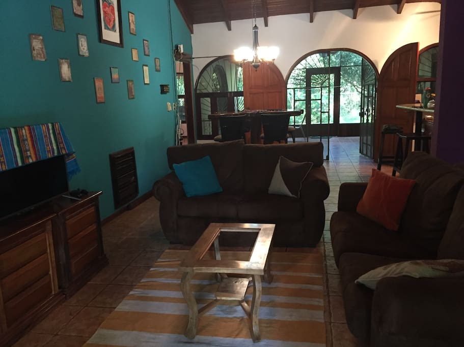 Open living and kitchen space with a lot of character - round windows and native wood ceilings.