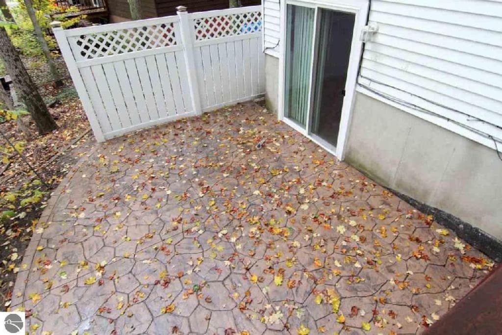 Stamped patio from walkout basement makes the perfect spot for a campfire! Fire pit isn't pictured, but is provided