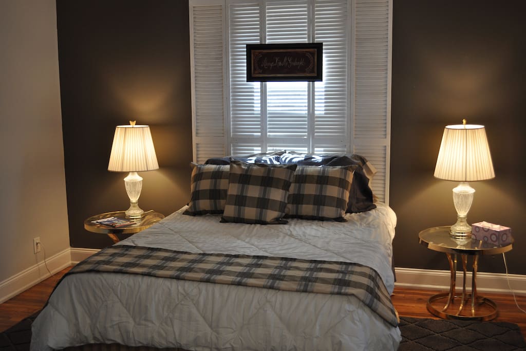 Very comfortable queen sized bed with side tables and a dresser for storage.
