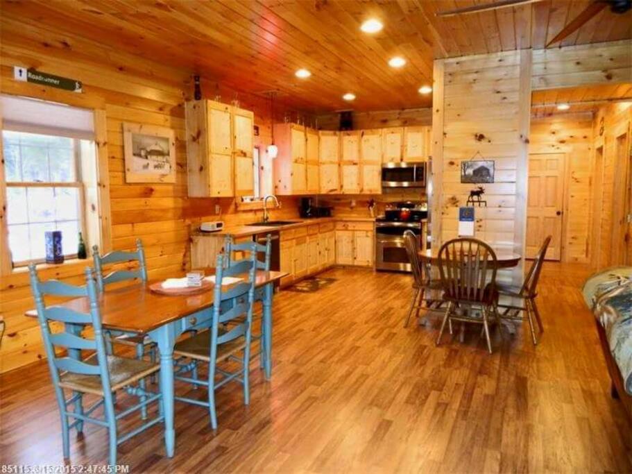 plenty of seating at both tables and in living room in front of tv and fire place