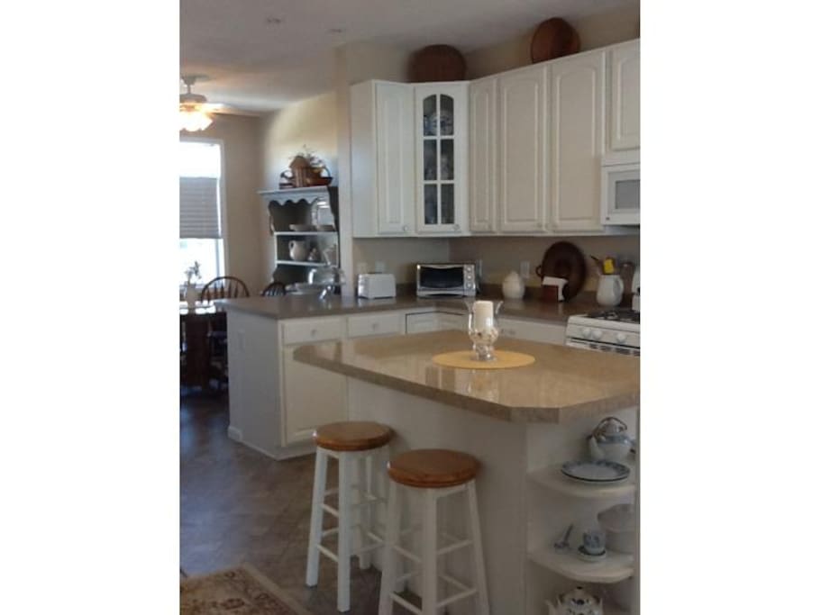 Kitchen with 3 breakfast nooks and a dining table for four with decks in front & in back of house