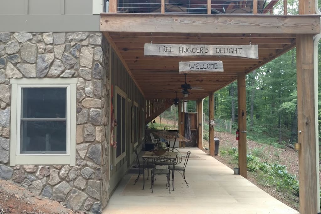 Porch has table, seating , hammock and outdoor shower