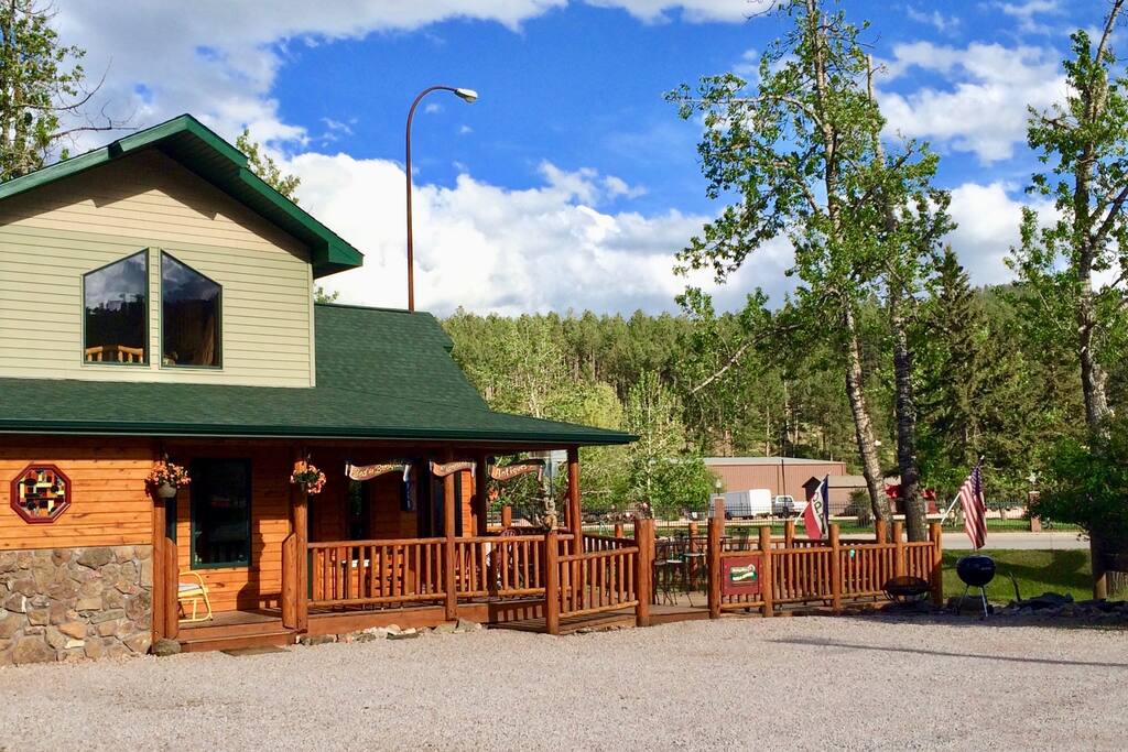 On the far right, see the small metal firepit and a charcoal grill adjacent to the large deck, for guest use.