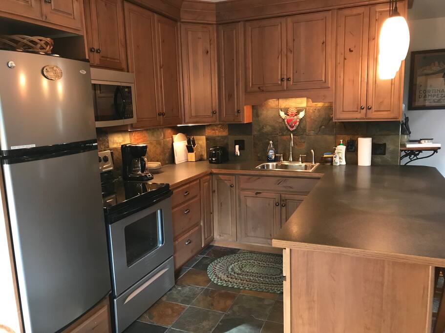 Kitchen fully stocked with dishes, pots & pans, cooking utensils