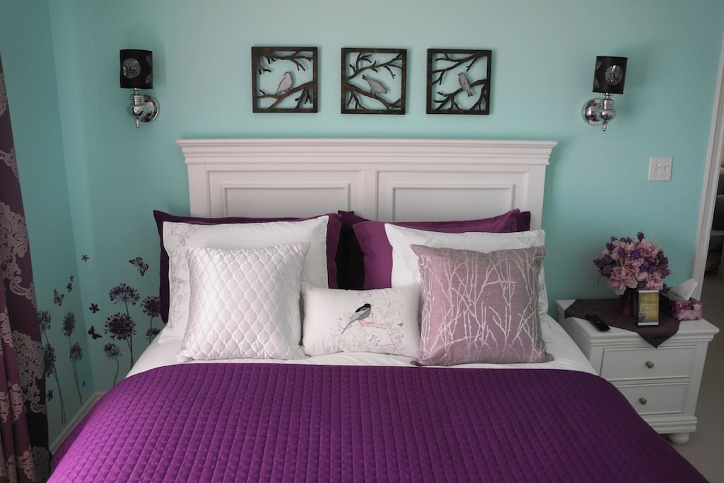 Queen bed, with empty dresser and nightstand for personal belongings.