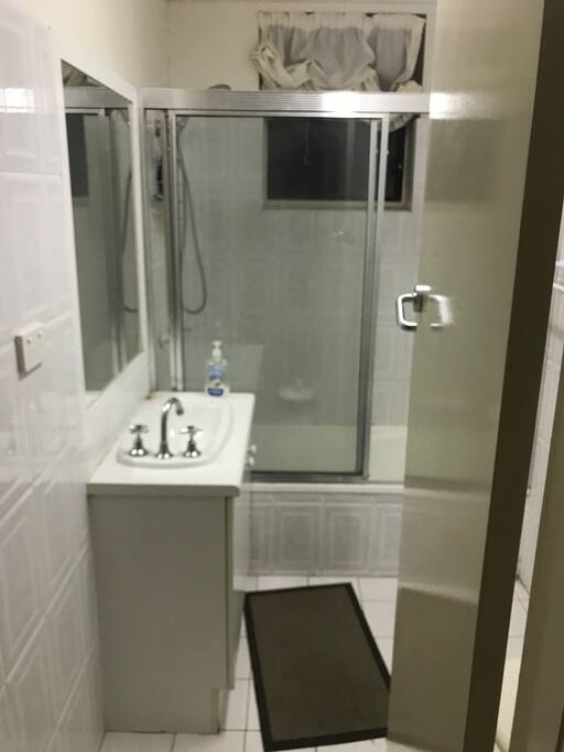 Bathroom step into bath tub shower NB toilet is also in the bathroom