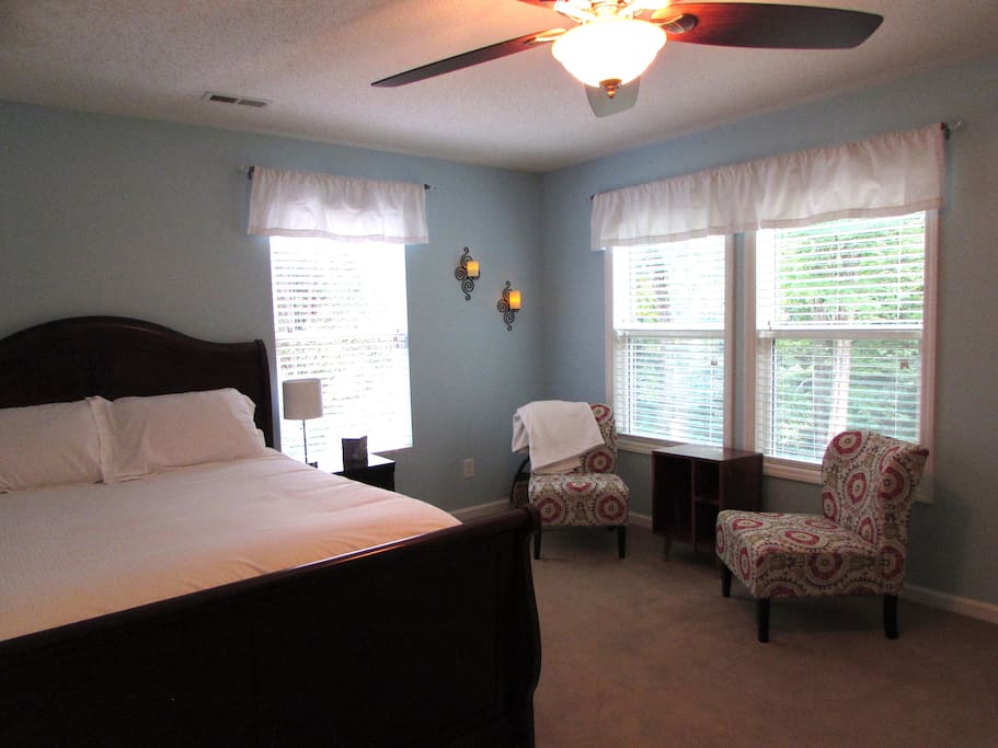Large bedroom suite with natural light and sitting area