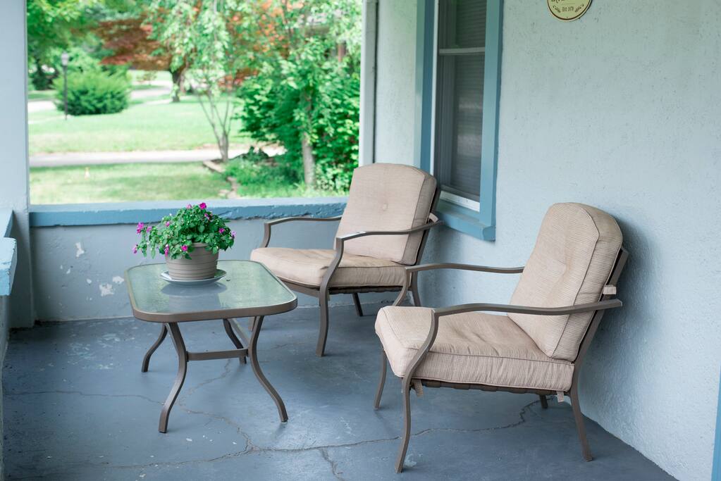 Large front porch chairs offer a great place for you to enjoy the quiet neighborhood