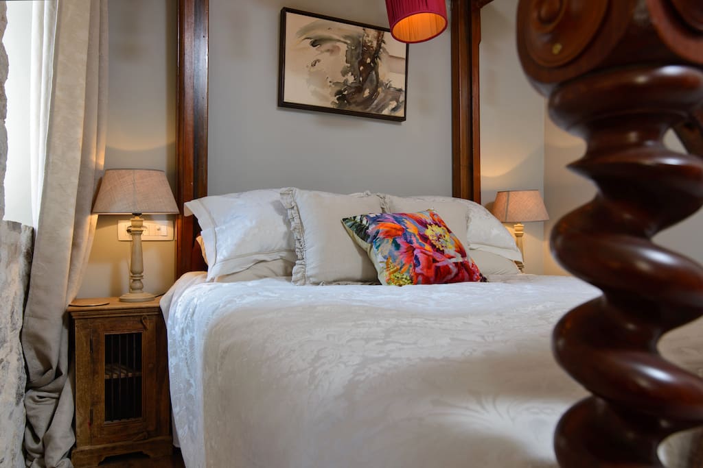 Antique bed with pure linen bedding and quality mattress.