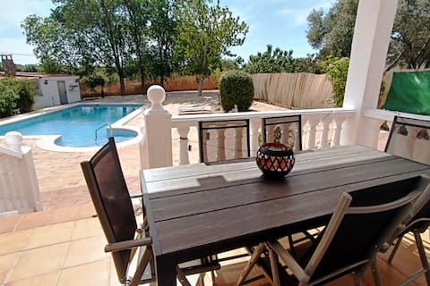 A villa with a pool and barbecue