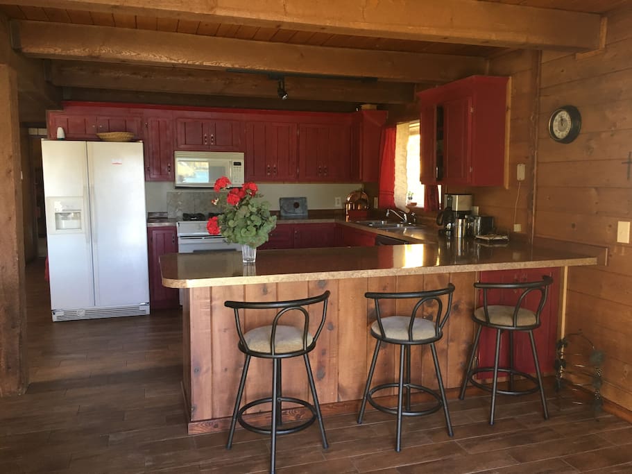 Large fully stocked kitchen with dining counter..