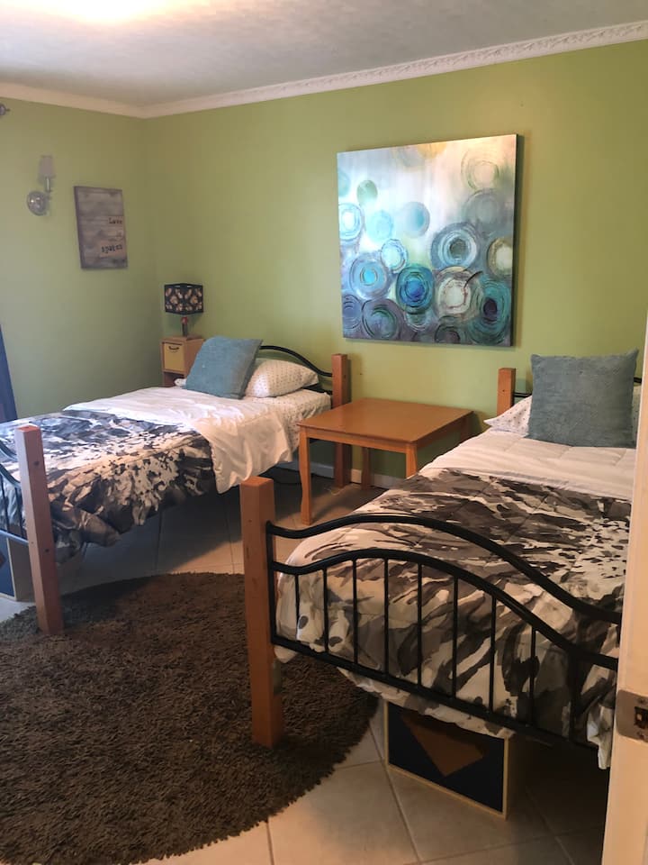 Two twin beds with pool access and view
