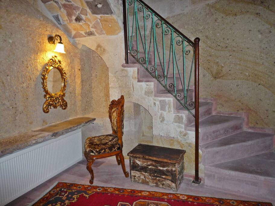 Roman suite cave bedroom, stone beauty table, stairs up to ground level sitting room.