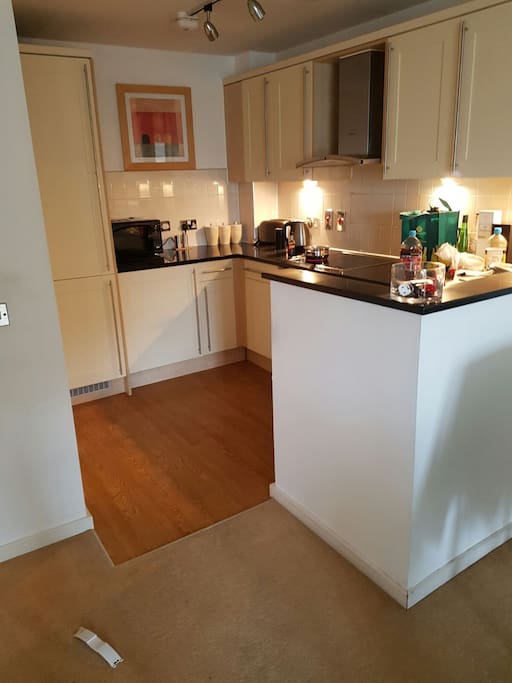 Modern kitchen with touchscreen hob and coffee machine.