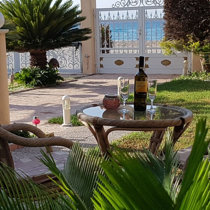 Enjoy sitting under the umbrella in the garden, sipping wine just a stones throw away from the beach.
