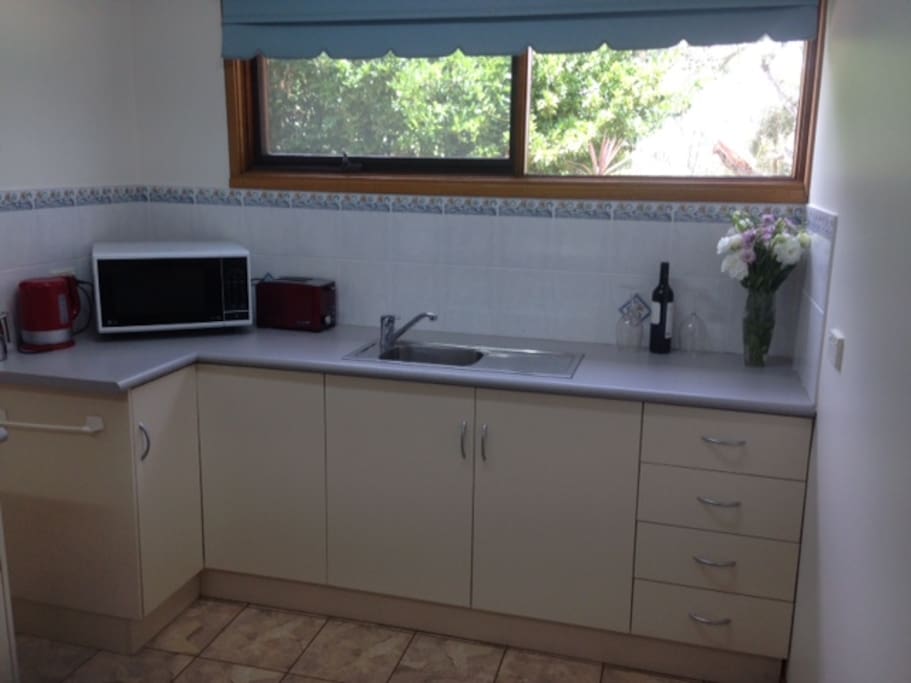 The kitchenette has a microwave, frypan, toaster and essential kitchenware.