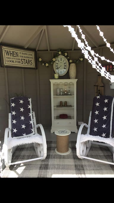 Relax in our wee summer house with a drink and enjoy the stars or sunshine whilst reading a book .