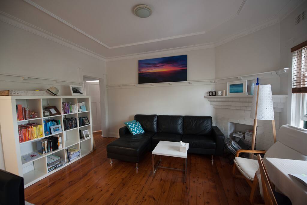 The living room - enjoy the leather sofa. Feel free to read the books or watch TV.