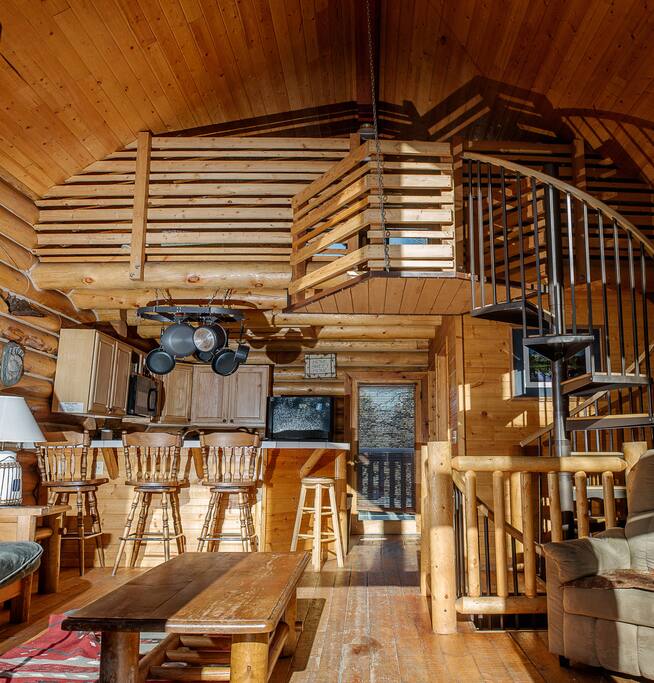 Follow the spiral staircase downstairs to an inviting master bedroom or up to the lofted guest room