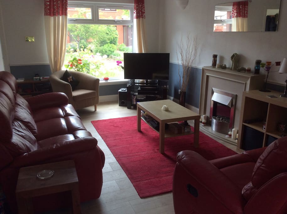 Living room with recliner sofas ( one 3 seater, one 2 seater) .