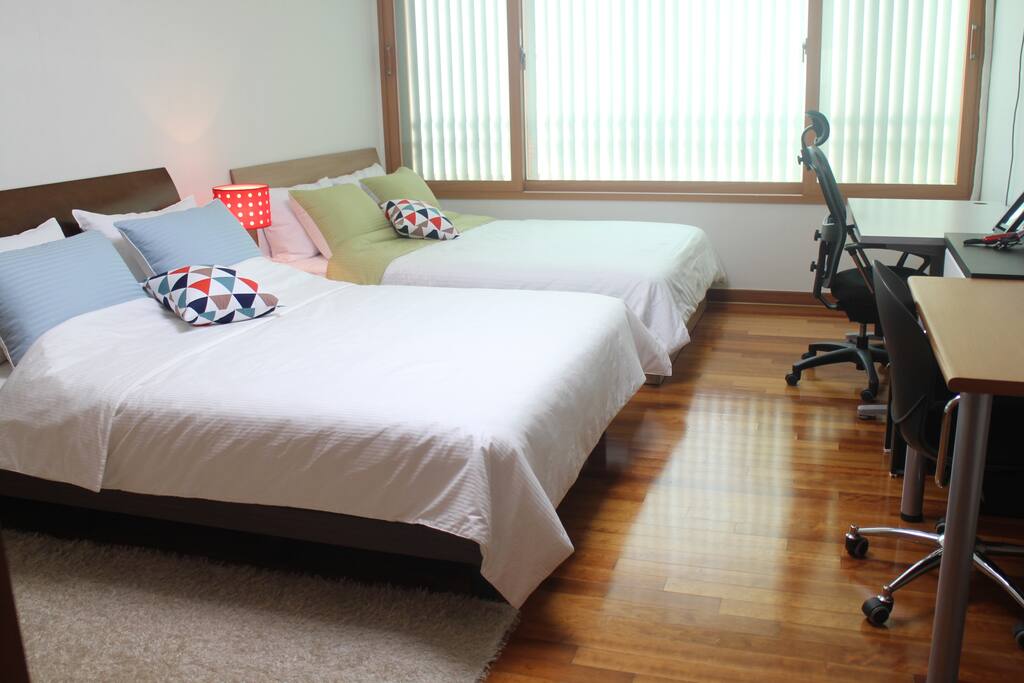 private room with 2 queen beds, a desk, a dressing table, a multi purpose table