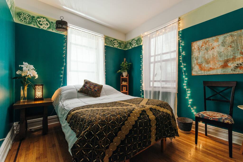 Full sized bed, night table, chair, ambient lighting for night
