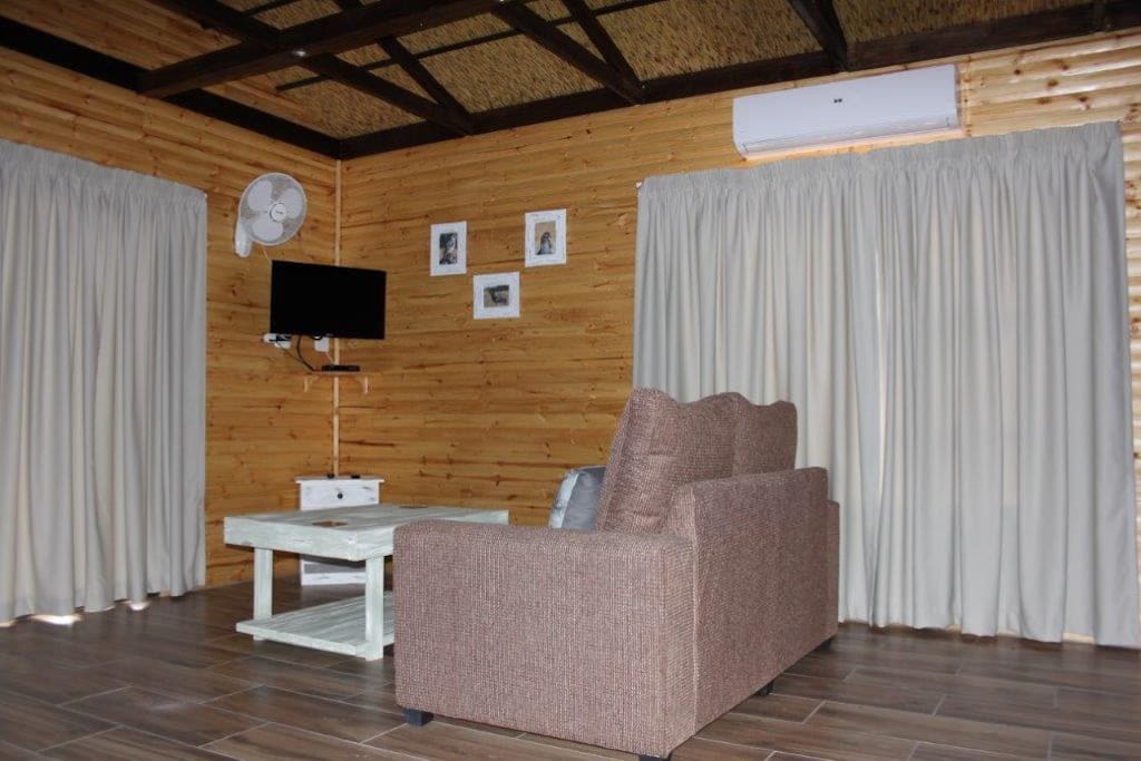 Sitting room area with TV and aircon
