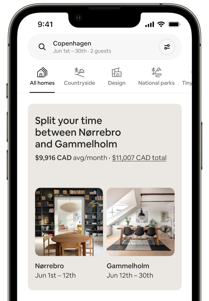 The screen of a cell phone shows a Split Stay. The screen says: “Split your time between Nørrebro and Gammelholm” and displays the price for the trip. Below, there are two photos of the homes. The Nørrebro image shows a dining room with a large charcoal bookcase and a modern chandelier. The Gammelholm image shows another dining room, this one lit by a large skylight. Each photo is captioned with dates, which make clear that the guest would spend 12 days in Nørrebro, followed by 18 days in the Gammelhorm home.