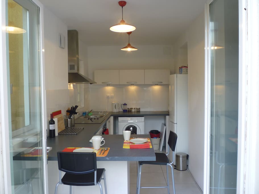 Stepping from the balcony into the bright, roomy kitchen.