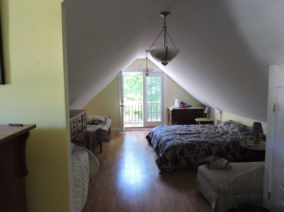 The Sleeping area - king bed and two twin beds, french windows over garden