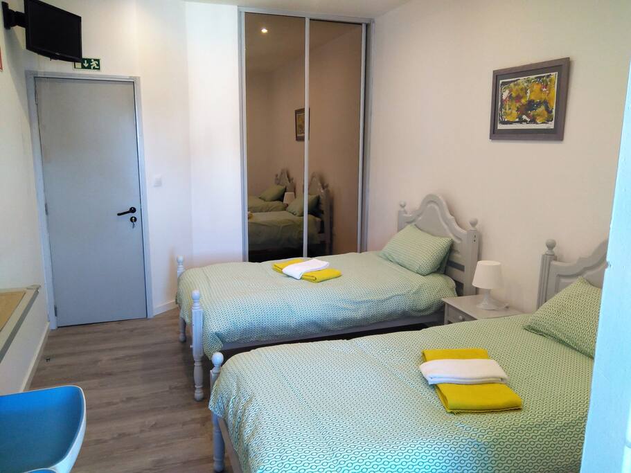 TV with Cable Chains, Wardrobe and Single Beds