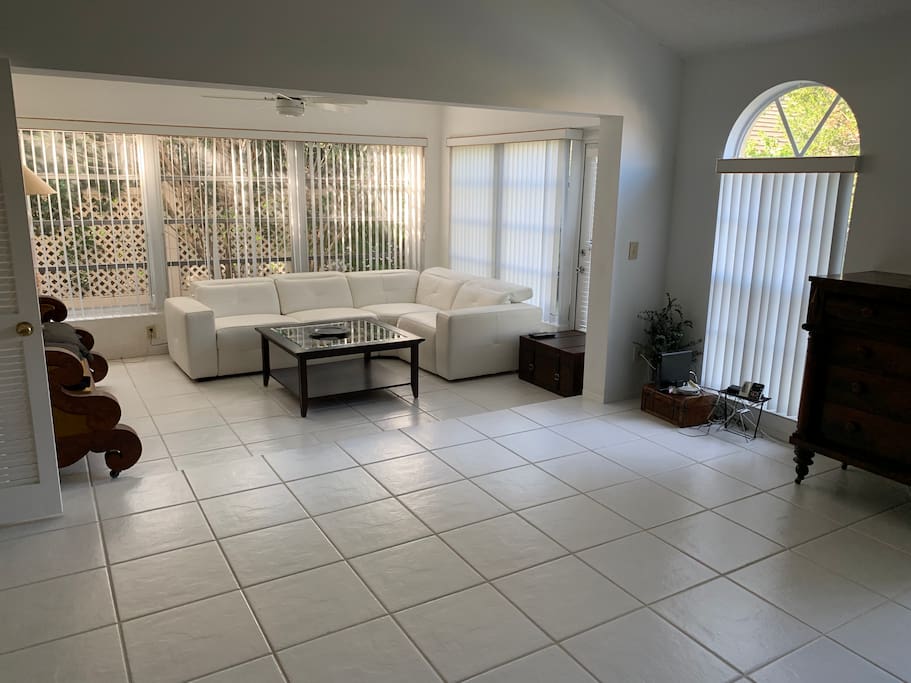 Spacious and bright living room with new white leather couch