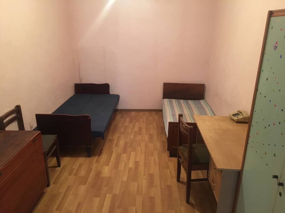 Two beds with chairs and table