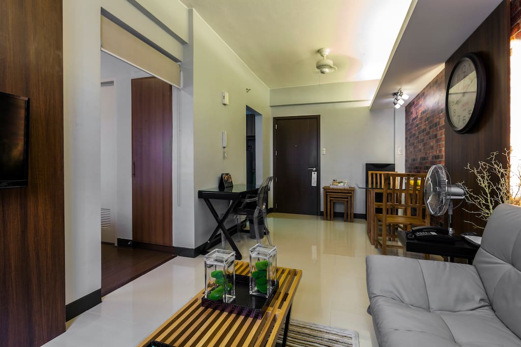 Classy and homey! Living room has 2 Hunter™️ ceiling fans
