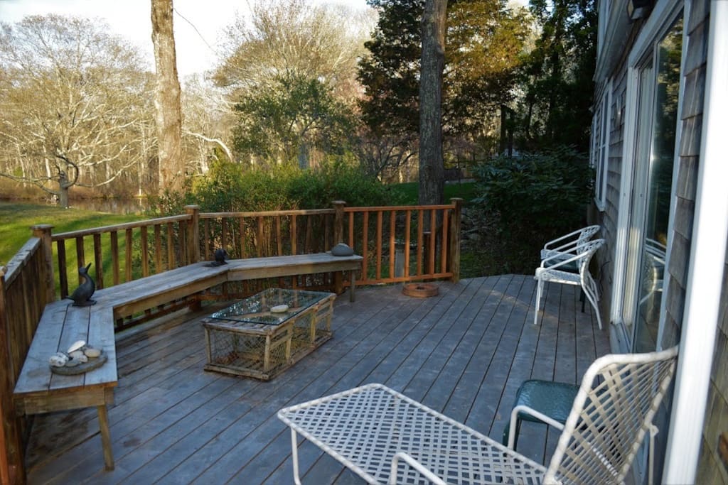 The deck off the living room with view of the pond