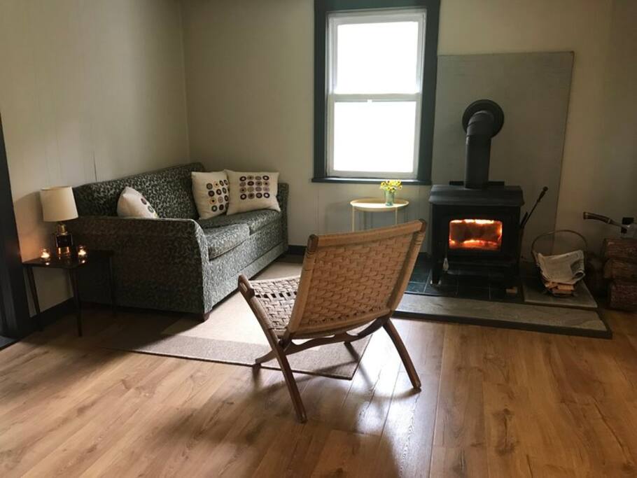 Living room with an easy to use wood burning stove - we supply firewood!