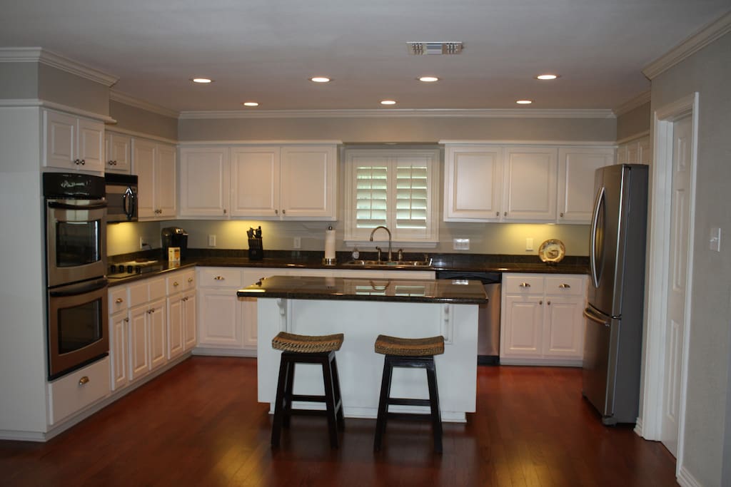 Kitchen with granite and stainless steel appliances.