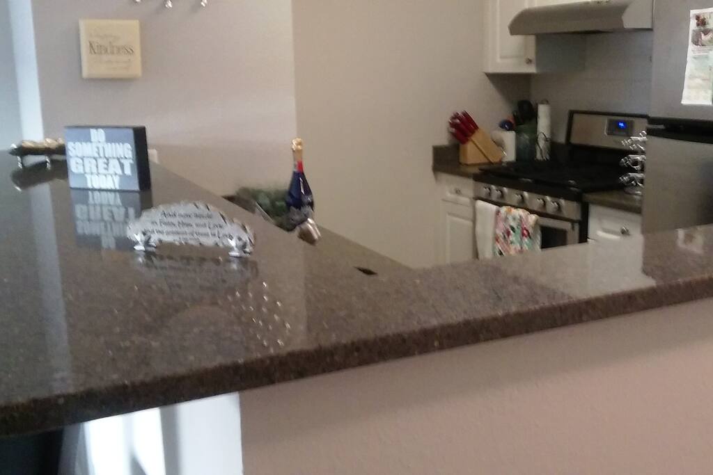 picture of island and of kitchen large amount of cabinet space for storage microwave..oven..fridgerator with ice maker.. toaster