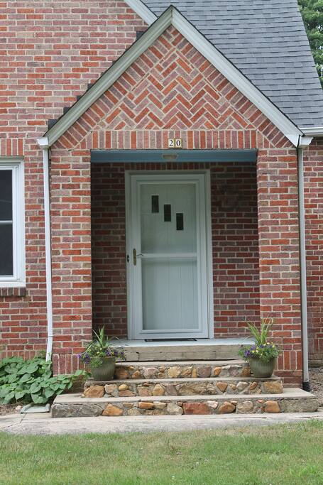 Beautiful front porch and stairs welcome you as you arrive