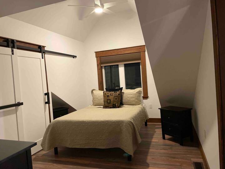 Bedroom 1 with queen bed, blackout blinds, clothing storage in large three drawer dresser and triple door closet. The 50" fire tv has access to Netflix and the Bell network