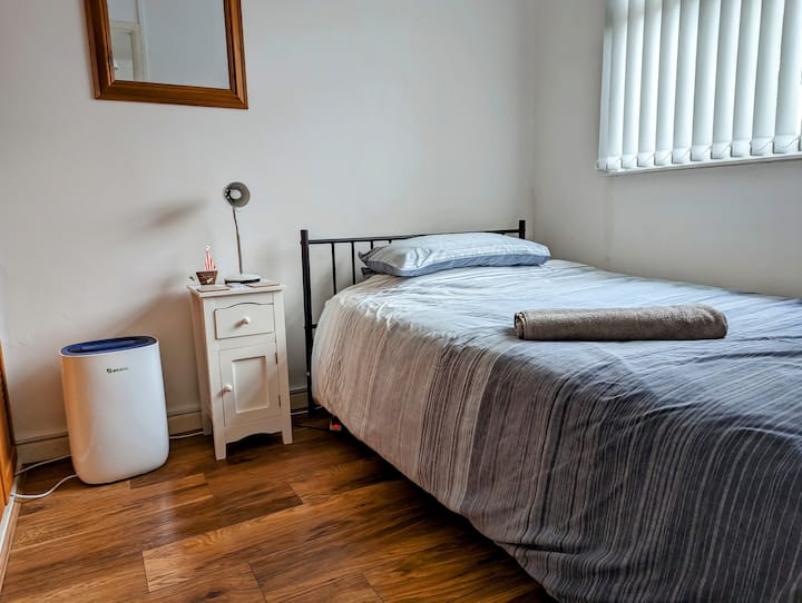 Front bedroom. Small double bed. 4' wide. Built in wardrobes and cupboards.