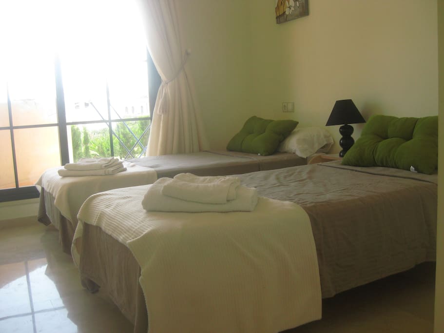 2nd Bedroom with 2 single beds and access to patio.